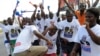 Supporters of Ghana's main opposition candidate Nana Akufo-Addo of the New Patriotic Party dance in the streets of Kasoa, center Ghana.