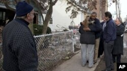 President Obama, accompanied by New York City Mayor Bloomberg, New York Gov. Cuomo and Sen. Schumer, D-N.Y., hugs Debbie Ingenito on Cedar Grove Avenue, Staten Island, New York, Nov. 15, 2012.