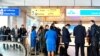 Travelers wait to be informed at the KLM Service Desk, regarding the U.S. travel ban for some European countries, in Schiphol, Netherlands, March 12, 2020. 