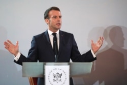 French President Emmanuel Macron speaks during a press conference at the Presidential Palace in Abidjan on December 21, 2019, during a three day visit to West Africa.