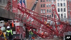 Firefighters and construction crews work on clearing a collapsed crane in New York, Feb. 6, 2016.
