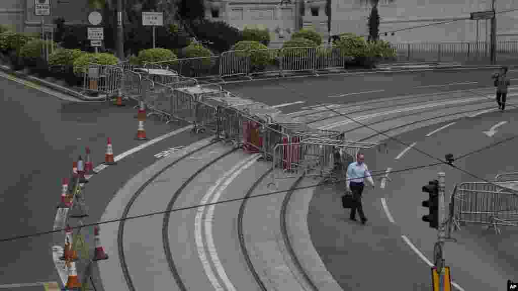 A man walks to work in the occupied areas at Central district in Hong Kong, Oct. 9, 2014. 