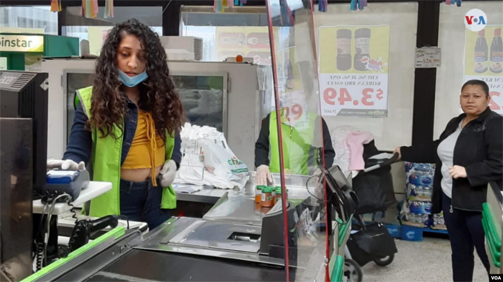 Las cajeras de los supermercados ahora portan guantes protectores, mascarillas y hay una ventana de acrílico para proteger, tanto al cliente como a la cajera, de posibles contagios causados por estornudos o tos. [Foto: Mitzi Macías]