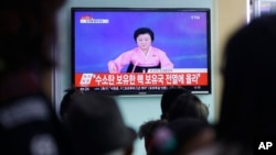 People watch a TV news program showing North Korea's announcement of a hydrogen bomb test, at the Seoul Railway Station in Seoul, South Korea, Jan. 6, 2016.