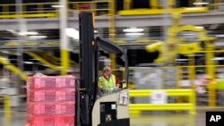 FILE - A forklift operator moves a pallet of goods at an Amazon.com fulfillment center in DuPont, Wash. This year, Amazon has been making an aggressive push to offer same-day delivery to its $99 annual Prime loyalty club members, Feb. 13, 2015.