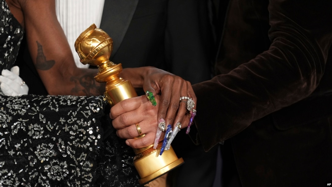 Cynthia Erivo, left, and Jon M. Chu pose with the award for cinematic and box office achievement for "Wicked" in the press room during the 82nd Golden Globes, Jan. 5, 2025, at the Beverly Hilton in Beverly Hills, Calif. 