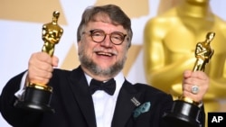 Guillermo del Toro, winner of the awards for best director and best picture for "The Shape of Water," poses in the press room at the Oscars, March 4, 2018, at the Dolby Theatre in Los Angeles.