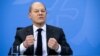 FILE - German Chancellor Olaf Scholz gestures as he speaks at a press conference at the Chancellery in Berlin, Dec. 21, 2021.