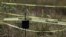 A cross stands among police tape set up to mark a mass grave found next to a cemetery in Tetelcingo, Mexico, Nov. 12, 2015.