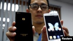 FILE - A man presents the Vietnamese smartphones Bphones at BKAV factory in Hanoi, Vietnam July 5, 2017.