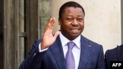 FILE - Republic of Togo's President Faure Essozimna Gnassingbe Eyadema gestures as he is welcomed by French President before a working lunch at the Elysee Presidential Palace in Paris on April 9, 2021.