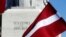 Latvia's national flag flutters next to the Freedom monument in Riga, Latvia, March 16, 2018. 