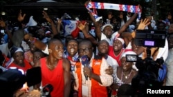 Supporters of Ghanaian presidential candidate Nana Akufo-Addo of the opposition New Patriotic Party (NPP) celebrate after he announced that he won the presidential election during a press conference at his private home in Accra, Ghana Dec. 8, 2016. 