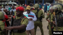 Tanzania's main opposition party CHADEMA's chairman Freeman Mbowe is detained by Tanzanian police during protests to condemn a series of kidnappings and murders within the Magomeni area of Dar es Salaam, Tanzania, Sept. 23, 2024.