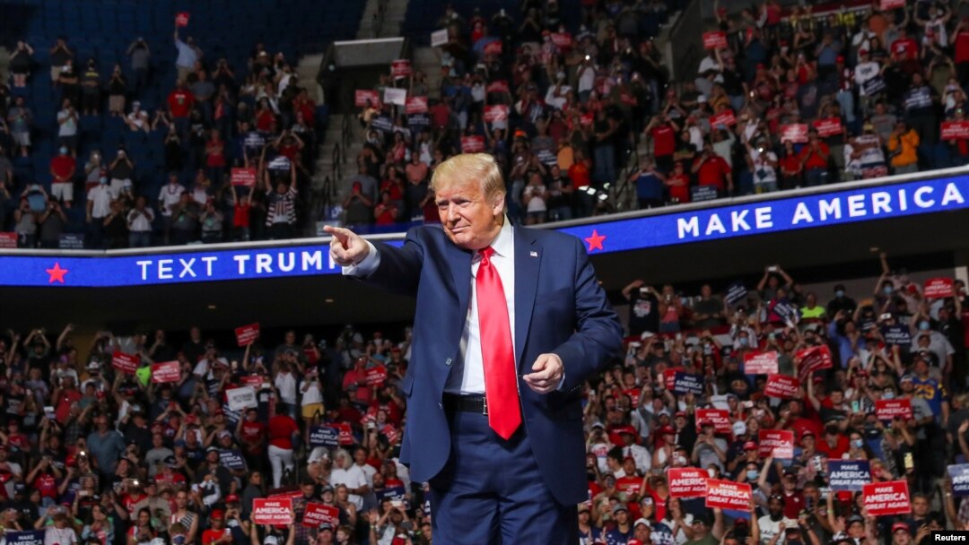U.S. President Donald Trump points at the crowd as he enters his first re-election campaign rally in several months in the midst of the coronavirus disease (COVID-19) outbreak, at the BOK Center in Tulsa, Oklahoma, June 20, 2020. 