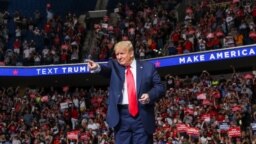 U.S. President Donald Trump points at the crowd as he enters his first re-election campaign rally in several months in the midst of the coronavirus disease (COVID-19) outbreak, at the BOK Center in Tulsa, Oklahoma, June 20, 2020. 