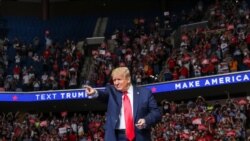 U.S. President Donald Trump points at the crowd as he enters his first re-election campaign rally in several months in the midst of the coronavirus disease (COVID-19) outbreak, at the BOK Center in Tulsa, Oklahoma, June 20, 2020.