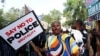 A protester holds a placard as Nigerians mark the one-year anniversary of the EndSARS anti-police brutality protest, in Abuja, Nigeria, Oct. 20, 2021.