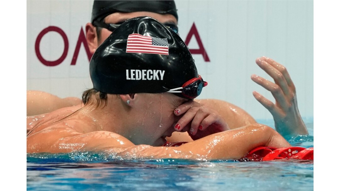 Katie Ledecky, front, of the United States, reacts after winning the women's 1500-meters freestyle final at the 2020 Summer Olympics, July 28, 2021, in Tokyo, Japan.