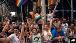 People cheer as floats travel along Fifth Avenue during the New York City Pride Parade, June 25, 2017.