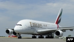 FILE - Emirates Airline's Airbus A380 lands for the first time at Schiphol Airport on August 1, 2012. The A380 is the largest and heaviest passenger plane in the world and can accommodate over 500 passengers. 