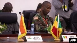 The national flags of Niger and Mali stand on a table during the Extraordinary meeting of Economic Community of West African States (ECOWAS) in Accra, Ghana, on August 17, 2023.