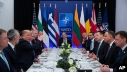 FILE - President Donald Trump speaks during a working lunch with leaders of NATO members countries that have met their financial commitments to the the organization, in Watford, England, Dec. 4, 2019.