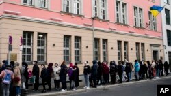 ARCHIVO: Ciudadanos ucranianos, en su mayoría refugiados que huyeron de la guerra, esperan ante el departamento consular de la embajada ucraniana en Berlín, Alemania, el 1 de abril de 2022. 