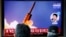 FILE - People watch a TV showing a file picture for a news report on North Korea firing two unidentified projectiles, in Seoul, South Korea, March 2, 2020.