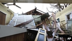 A library in the small community of Cardwell, Australia, is without a roof and badly damaged after Cyclone Yasi brought heavy rain and howling winds, February 4, 2011