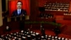 China's Premier Li Keqiang is seen on a screen delivering the government work report during the opening ceremony of the National People's Congress (NPC) at the Great Hall of the People in Beijing, March 5, 2014.