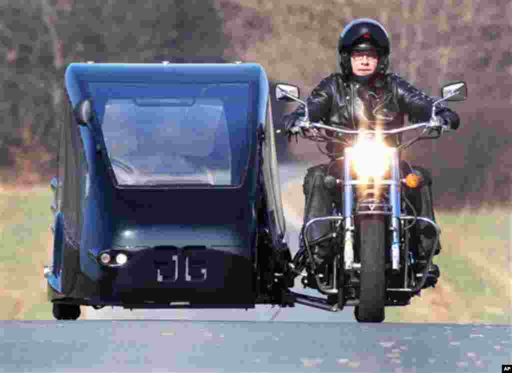 TO GO WITH STORY 'HARLEY HEARSE ' Joerg Grossmann drives his motorcycle combination with a Kawasaki VN 1500 fitted with a sidecar on a road near Usingen, Germany, on Friday, March 16, 2012. The 48 year old Grossmann who calls himself a chauffeur for the