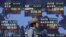 A man walks past a stock quotation board outside a brokerage in Tokyo, Japan, September 14, 2012. 