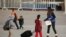 FILE - Migrant children from Central America walk at the Leona Vicario temporary migrant shelter before being transferred to continue their asylum request in the U.S., in Ciudad Juarez, Mexico, Feb. 26, 2021.