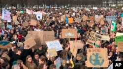 Some thousands of students gather to join a march in support of more ambitious climate policies in The Hague, Netherlands, Thursday Feb. 7, 2019.