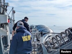 FBI agents process the remains of a balloon shot down by U.S. military off South Carolina