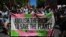 People participate in a rally during a global day of action on climate change in Sydney on Nov. 6, 2021, as world leaders attend the COP26 UN Climate Change Conference in Glasgow. 