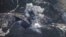 In this photo made from the footage taken from Russian Defense Ministry official web site on Sunday, Oct. 4, 2015, an aerial view of a bomb explosion in Syria.