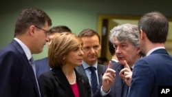 EU Commissioner for Internal Market Thierry Breton, second right, speaks with EU for Crisis Management Janez Lenarcic, left, and EU Commissioner for Health Stella Kyriakides, meeting in Brussels, March 6, 2020. 