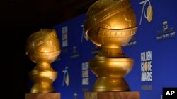 FILE - Golden Globe statues appear on stage prior to the nominations for 75th Annual Golden Globe Awards at the Beverly Hilton hotel in Beverly Hills, Calif., Dec. 11, 2017. 