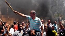 Egyptians chant slogans during clashes between supporters and opponents of Egypt's president and his Muslim Brotherhood in Luxor, Egypt, June 19, 2013.