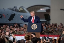 FILE - U.S. President Donald Trump gestures during his visit to U.S. troops based in Osan Air Base, South Korea, June 30, 2019.