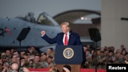 U.S. President Donald Trump gestures during his visit to U.S. troops based in Osan Air Base, South Korea, June 30, 2019.
