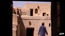 FILE —A man walks in Bahla Fort, one of four historical forts located at the foot of the Green Mountain highlands in Oman, and the only fort in the country designated a UNESCO Heritage Site, in Bahla, 200km north of Muscat, on October 5, 2023.