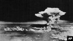 In this Aug. 6, 1945 photo released by the U.S. Army, a mushroom cloud billows about one hour after a nuclear bomb was detonated above Hiroshima.