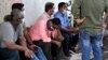 Relatives of missing personnel who were on a barge that sank in the Arabian Sea await outside a morgue at a hospital in Mumbai, India, May 20, 2020. 