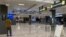 FILE - Travelers walk in a quiet arrivals terminal at Washington Dulles International Airport in Dulles, Virginia, Nov. 19, 2020. 