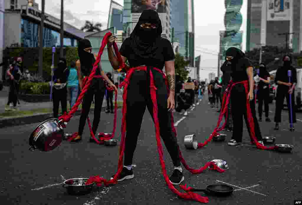 A group of women perform during a protest against charges ofcorruption and the lack of measures with a gender perspective, in Panama City, Panama, Sept. 2, 2020.