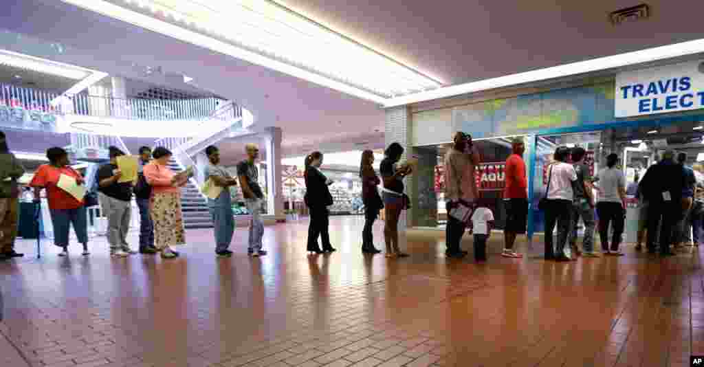 Voters wait in line at a polling place located inside a shopping mall in Austin, Texas. 