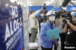 A public relation officer of the Japan Aerospace Exploration Agency (JAXA) explains the launch failure of the H3 rocket at Tanegashima Space Center on the southwestern island of Tanegashima. (Kyodo via REUTERS)